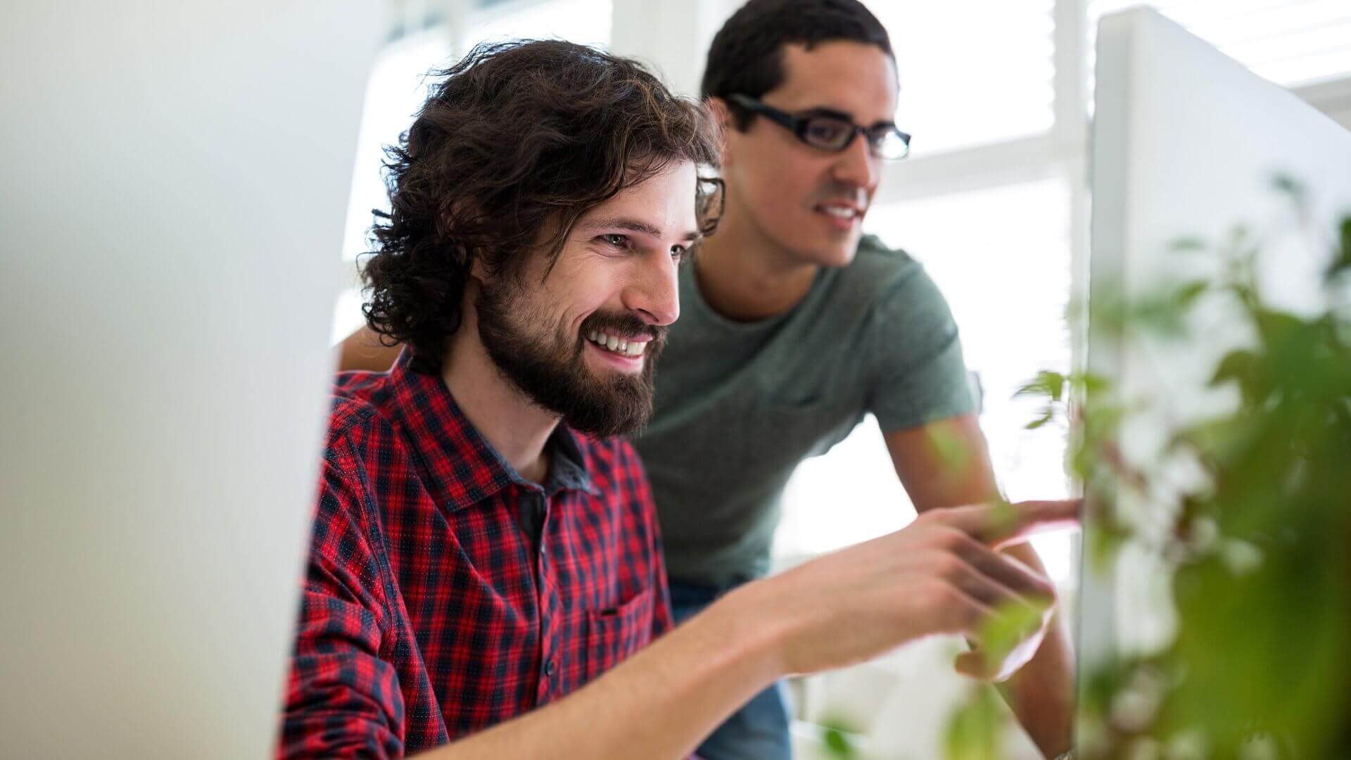 two men starting at computer screen